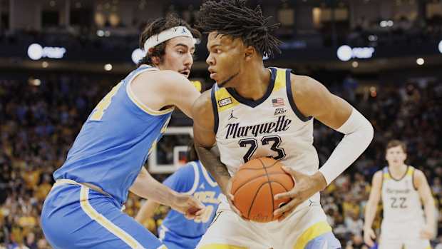 Dec 11, 2021; Milwaukee, Wisconsin, USA; Marquette Golden Eagles forward David Joplin (23) looks to shoot against UCLA Bruins guard-forward Jaime Jaquez Jr. (24) during the first half at Fiserv Forum. Mandatory Credit: Jeff Hanisch-USA TODAY Sports